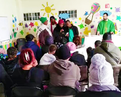 Haitian women singing at Casa del Migrante